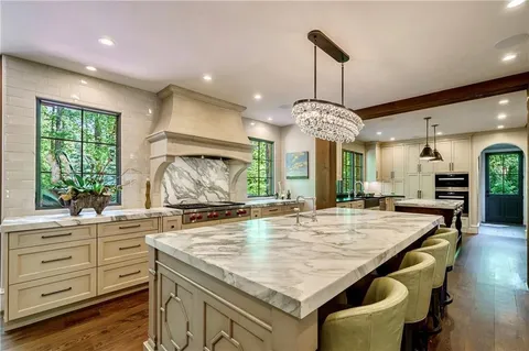 Luxury kitchen with marble countertops and crystal chandelier